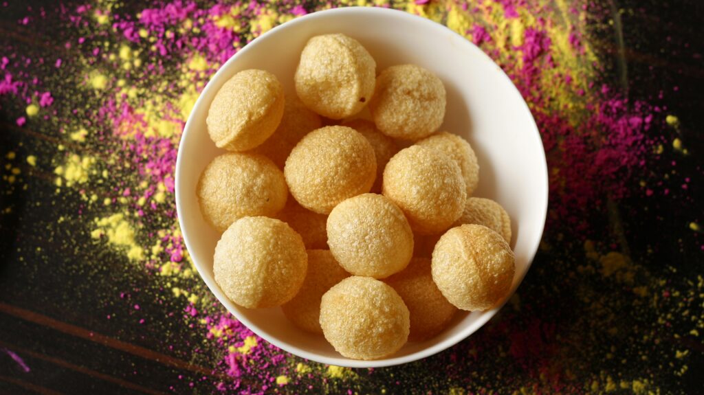 Young entrepreneur preparing Pani Puri at a street food stall-Teluguways.com