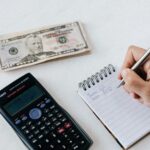 Person saving money in a jar, representing the 30-Day Money Savings Challenge with practical tips and financial discipline- Teluguways.com