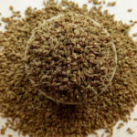 A bowl of Ajwain seeds with a wooden spoon, highlighting its health benefits for digestion, weight loss, and heart TeluguWays.com